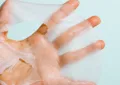 Close detail of sheet mask material held in hand